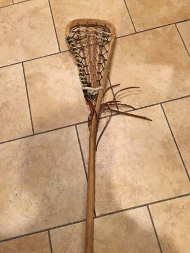 Traditional wooden lacrosse stick.