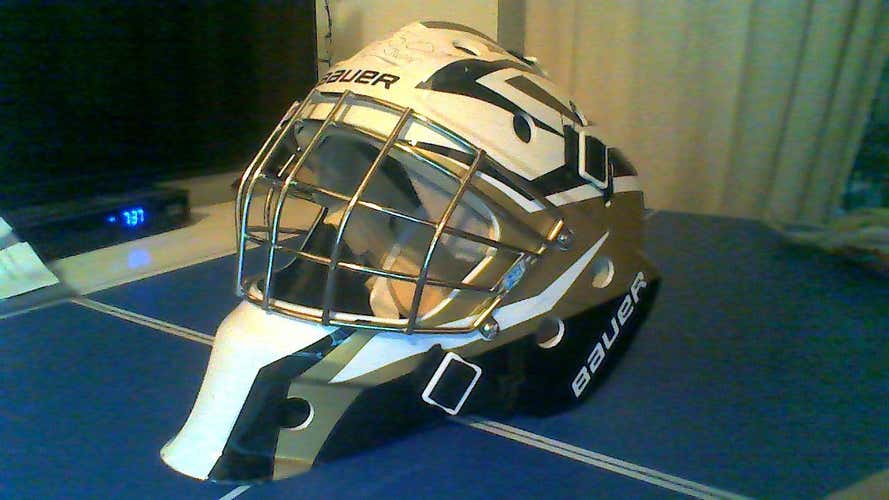 goalie helmet bauer black, white, and gold barley used