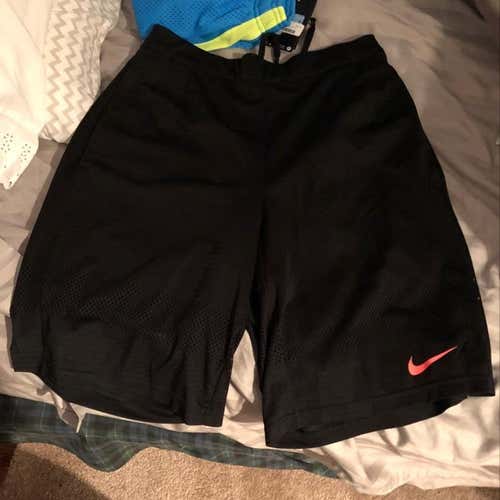 Black Nike Shorts With Pink Nike Logo.