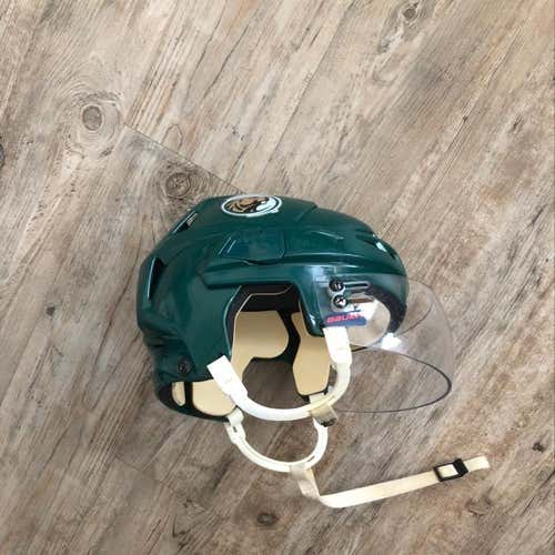College Hockey Helmet With Bauer Visor On It