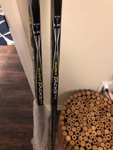 A Pair Of Ccm Supertacks 2.0 Brand New! 2 Sticks. LH 75 Flex P28 Curve