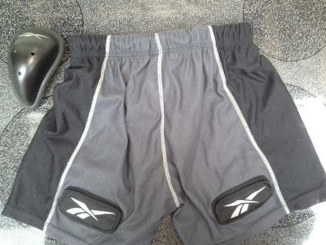 New, but missing packaging. Reebok 4K jock shorts with cup, and front - rear velcro.