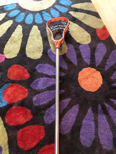 Warrior Youth Lacrosse Stick. Orange Head With Heavy Blue Mesh And Sliver Shaft