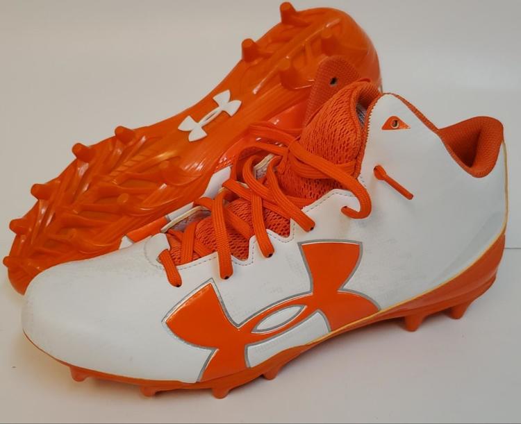 orange and white under armour football cleats