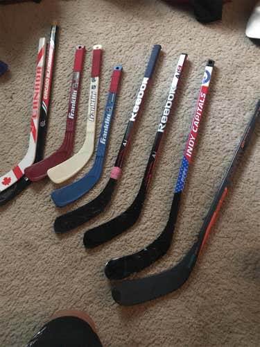 Lot of knee hockey sticks and goals