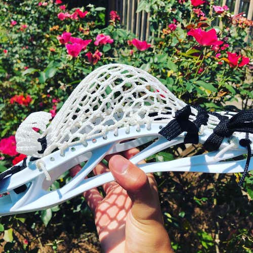 A white head with black strings. Clean look consistent pocket and nice hold. (price negotiable)