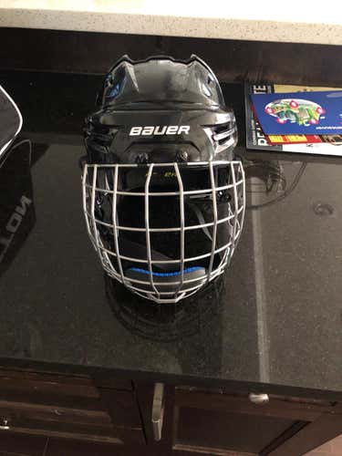 Large Bauer Reakt Helmet with new straps, ear pieces and cage.