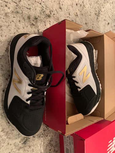 Brand New White black and gold new balance turf shoes