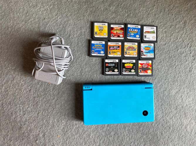 Sky Blue Nintendo DSi with an assortment of games