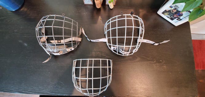 Three Used Medium cages two Bauer one Easton