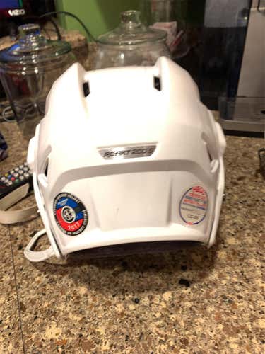White Used Small Bauer Re-Akt 200 Helmet with New Silver Cage