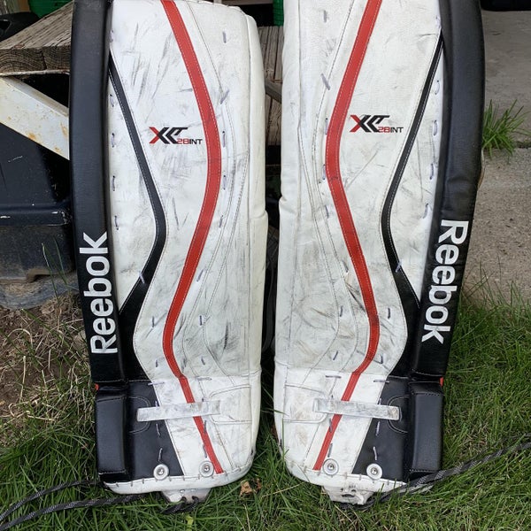 Used 32" Reebok Premier X28 32”+1” Goalie Leg Pads (White/Black/Red)