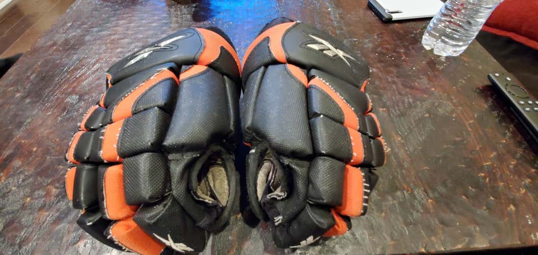 Black and orange  Used Junior Reebok 6K Gloves 11"