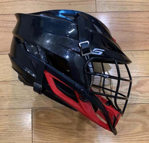 Lightly Used Cascade S Youth Helmet. Black shell, black cage, black chinstrap, red chin & washer.