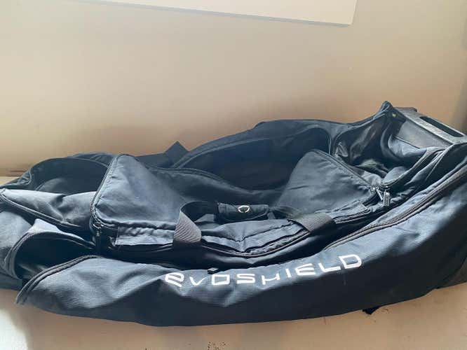 Navy Evoshield stone wheeled catchers bag
