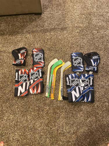 Used Knee Hockey Gear 6 Sticks Two Sets Of Goalie Pads