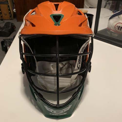 Orange Cascade R Lacrosse Helmet With Black Cage And Green Accents
