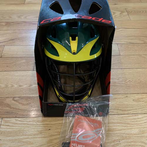 New in Box. Cascade S. forest green shell, black cage & strap, yellow jaw,washer, yellow decal