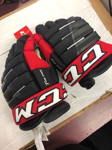 Black New Junior CCM Tacks 4 Roll Pro Gloves 12"