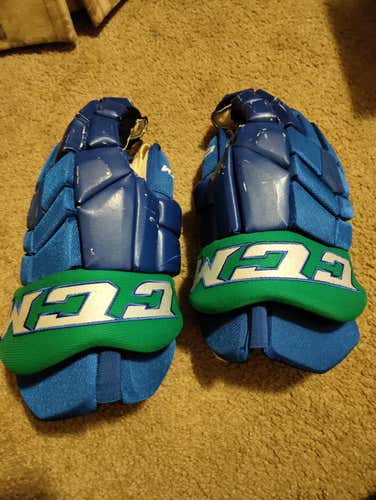 Blue and green ccm gloves