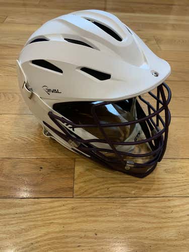Lightly used STX Rival Helmet. matte white shell, white strap, purple cage and jaw.S/M size.