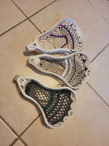3 used lacrosse heads.