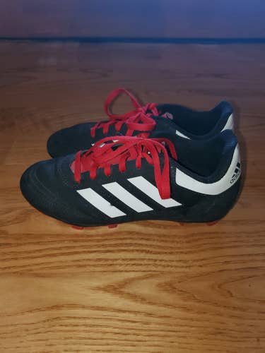 US 2.5. Very good condition black Adidas cleats.