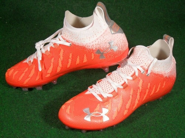 orange and white under armour cleats
