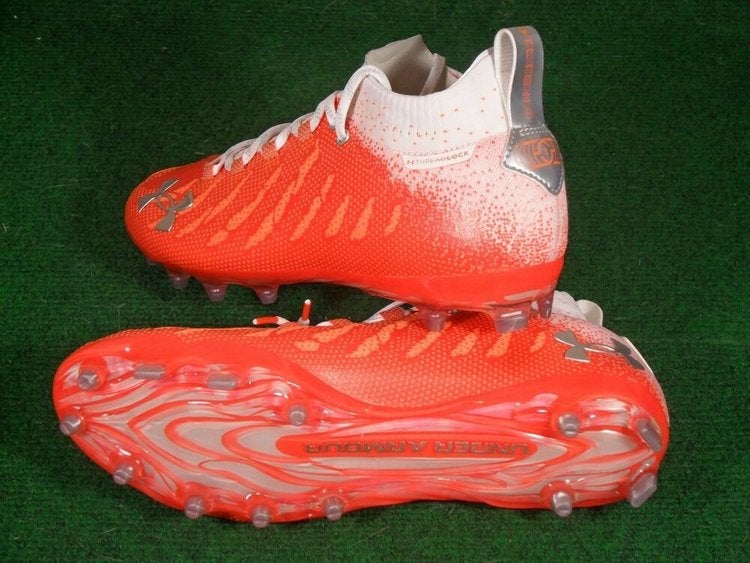 orange and white under armour cleats