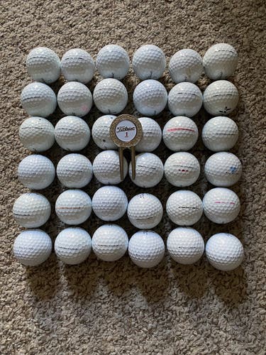 3 dozen Titleist pro V1 and divot tool