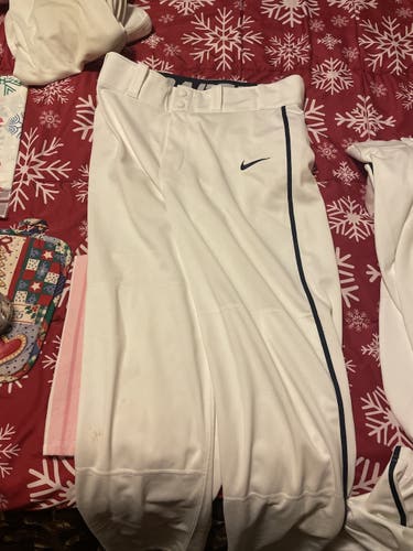 Barely used white Nike swing man pants with blue piping size small