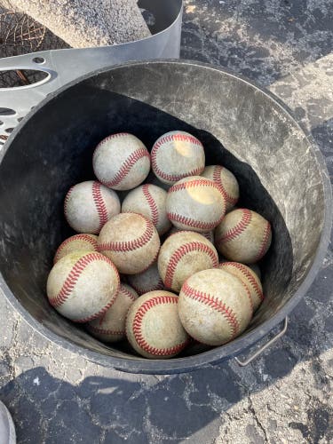 Used bucket of leather baseballs