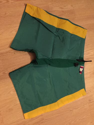 GREEN AND GOLD HOCKEY PANT COVER UPS SIZE MEDIUM
