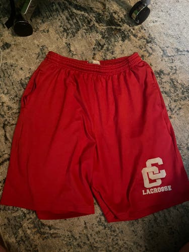Mens medium lacrosse shorts charlotte catholic red (hole in right pocket)