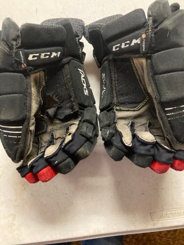 Red, black, and white used CCM Tacks 7092 Gloves 13"