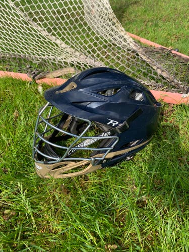 Cascade R lacrosse helmet. navy blue and gold helmet with chrome face mask.