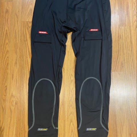 Black New XXL CCM hockey, base layer pant with velcro sock attachment.
