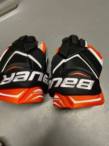 slightly used black and orange Bauer 13" Vapor X850 pro Gloves