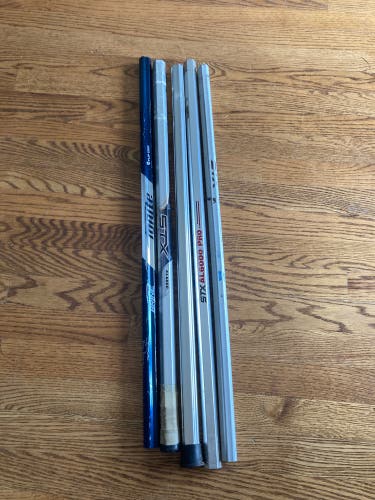 Five used lacrosse shafts