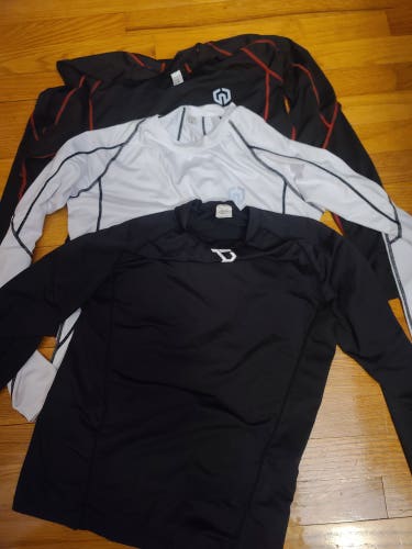 (3) Used Medium/Large Compression Shirts