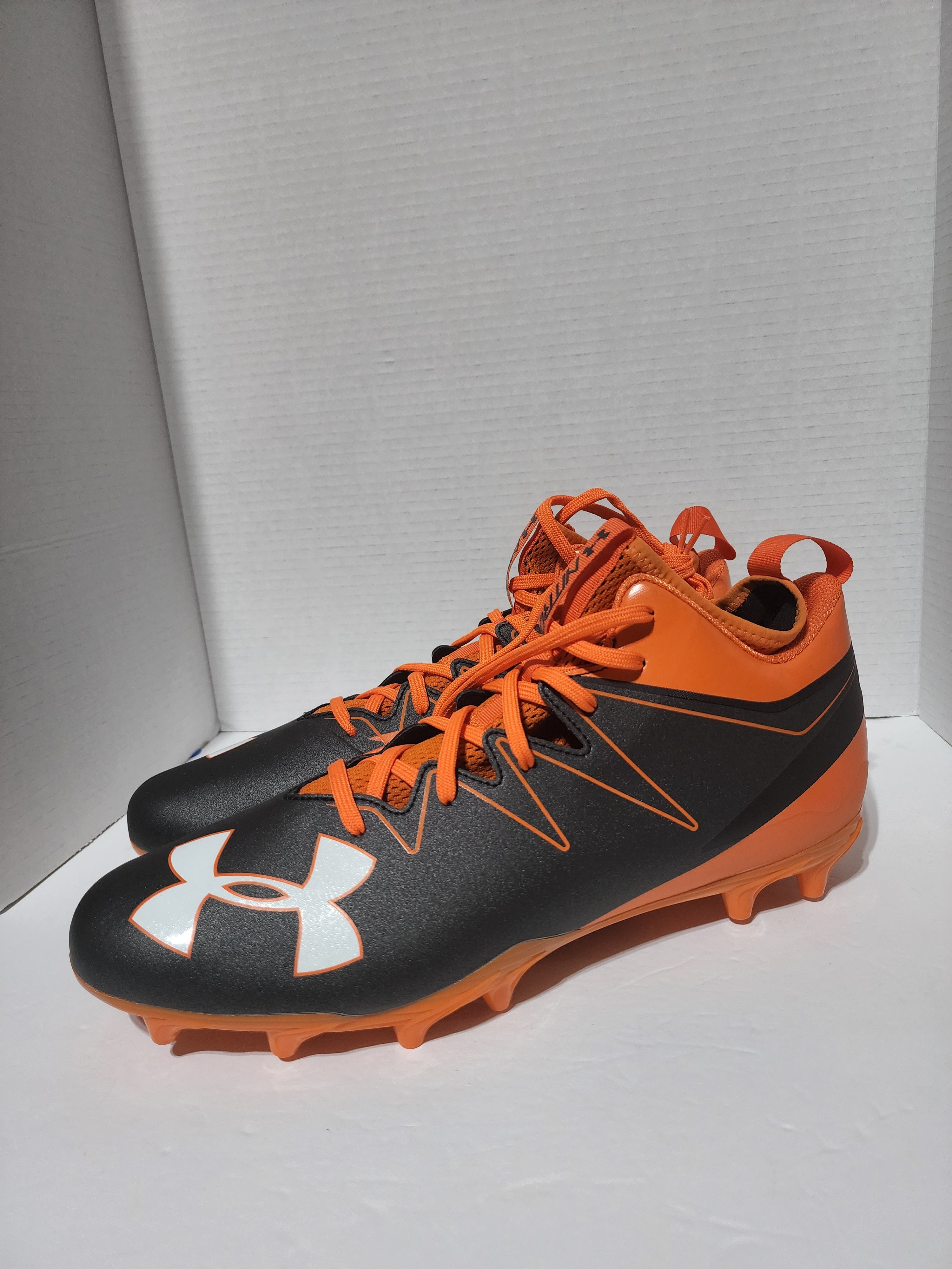 orange and black under armour football cleats