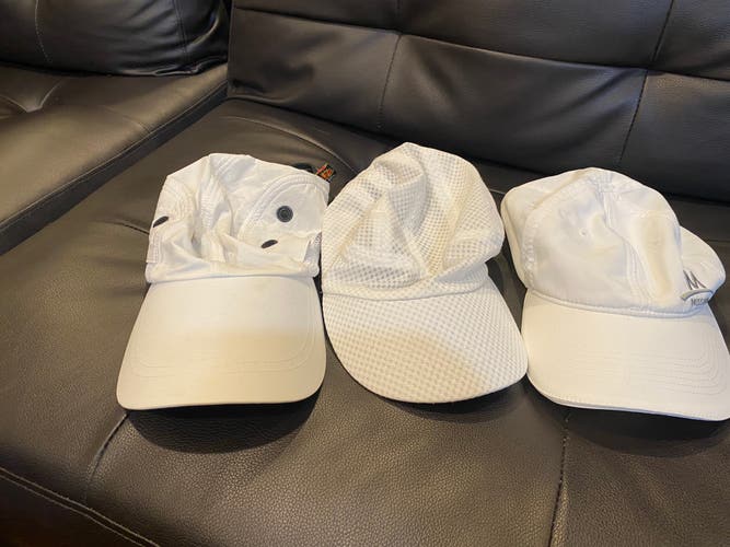 Three ladies white golf hats