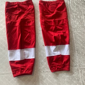 Red practice hockey socks with white stripes