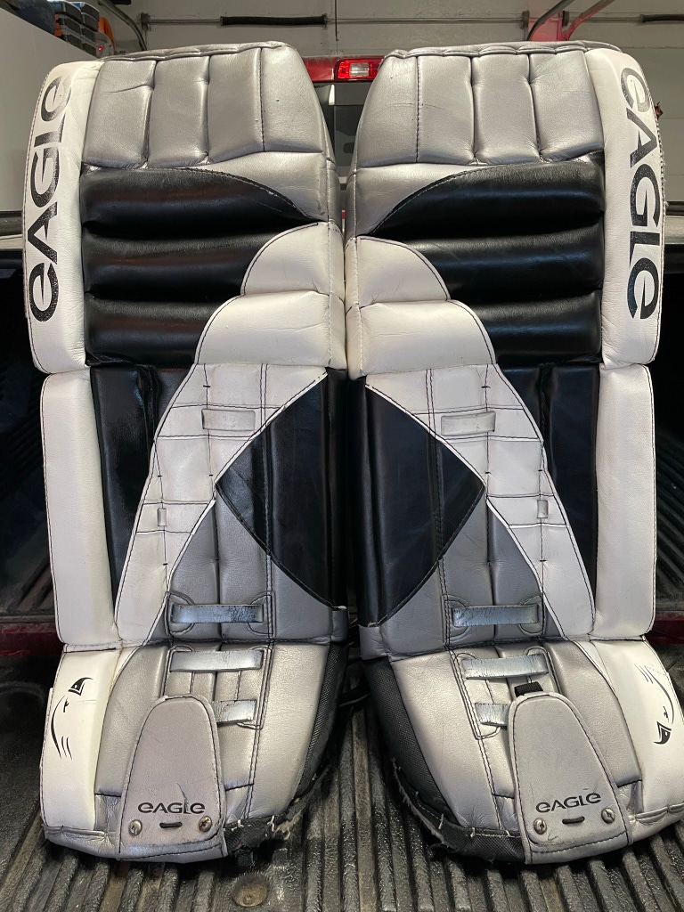 Used 34" Eagle PMW1 Pro Goalie Leg Pads. Black, Silver White. Good condition.