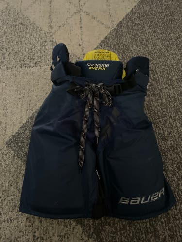 slightly used Navy blue Junior Large Bauer Supreme Matrix Hockey Pants