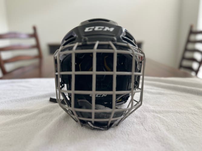 Lightly used CCM Tacks 310 black helmet with cage - Size medium with certified date of 2028