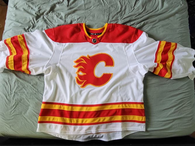 Brand new with tags- Adidas Made in Canada Calgary Flames away Jersey , size 58G - goalie cut