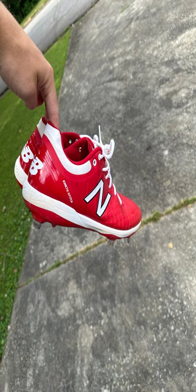 black and orange new balance cleats