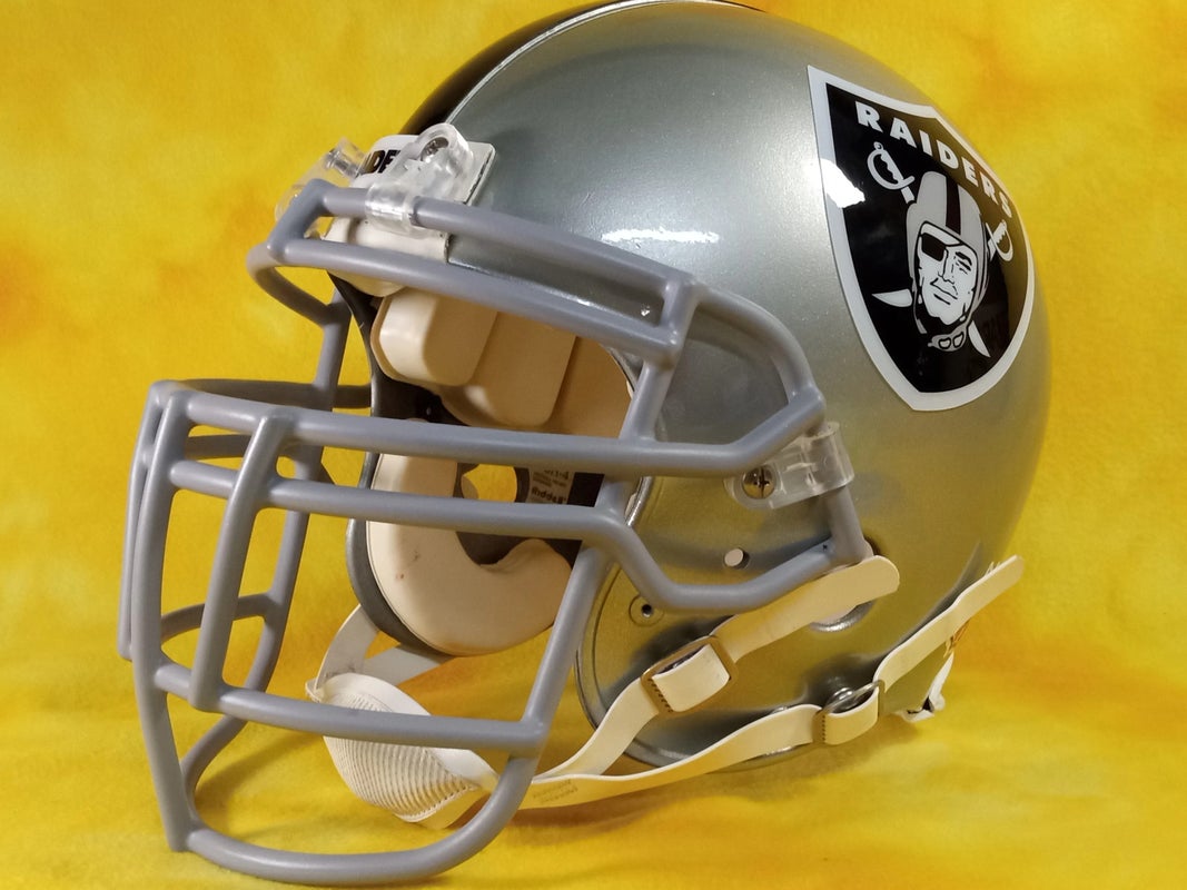 Raiders Old Helmet With Human Skull On Grass Field HD Raiders