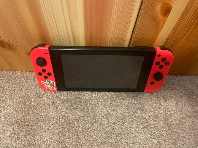 Original Nintendo switch with (neon red joy cons) and three games included